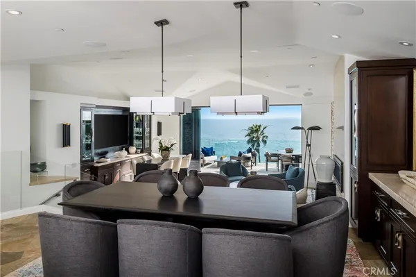 a kitchen with a counter space a sink and living room view