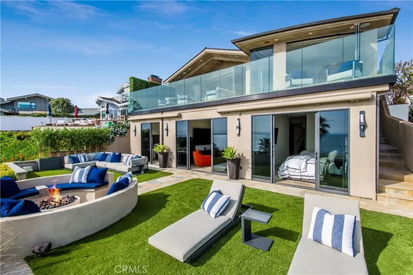 a view of a house with swimming pool and furniture