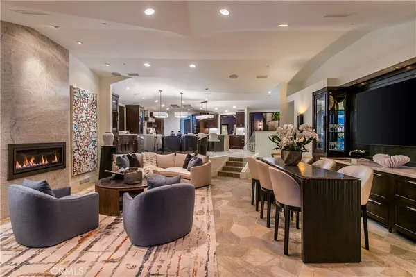 a living room with furniture a rug and a flat screen tv