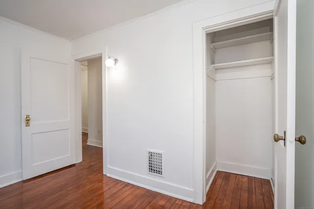 a view of an empty room and wooden floor