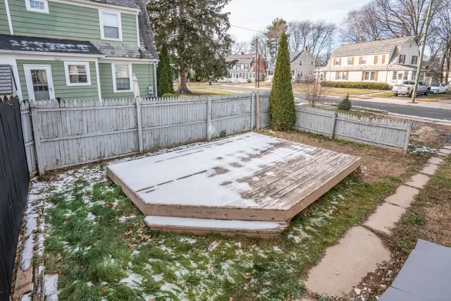 a view of a backyard with a sink and wooden fence