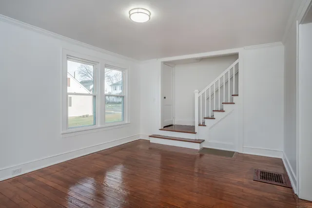 wooden floor in an empty room with a window