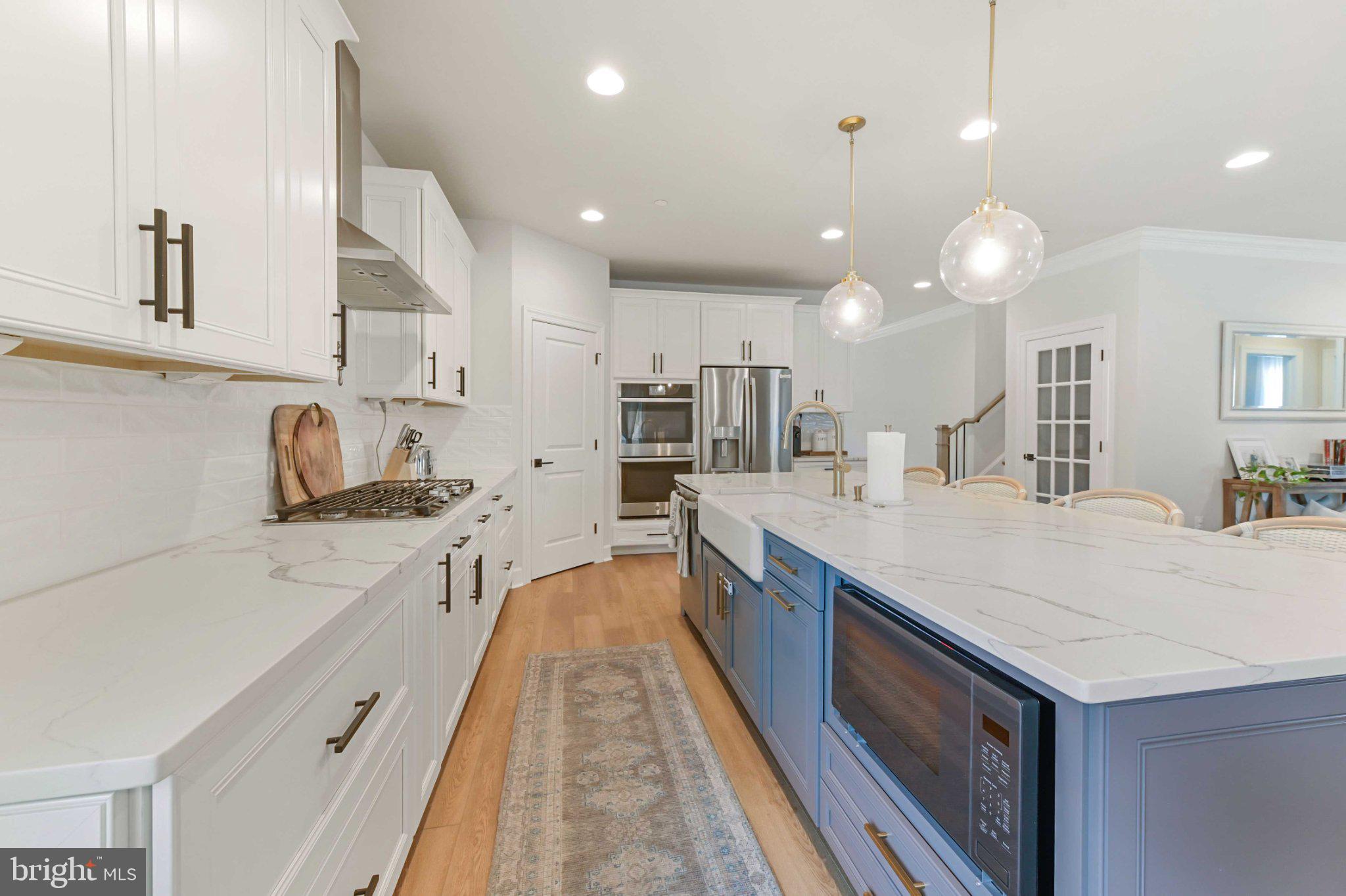 6310 Winters Lane Hanover, MD 21076 - Photo 11 of 76 a large kitchen with granite countertop lots of counter space and sink