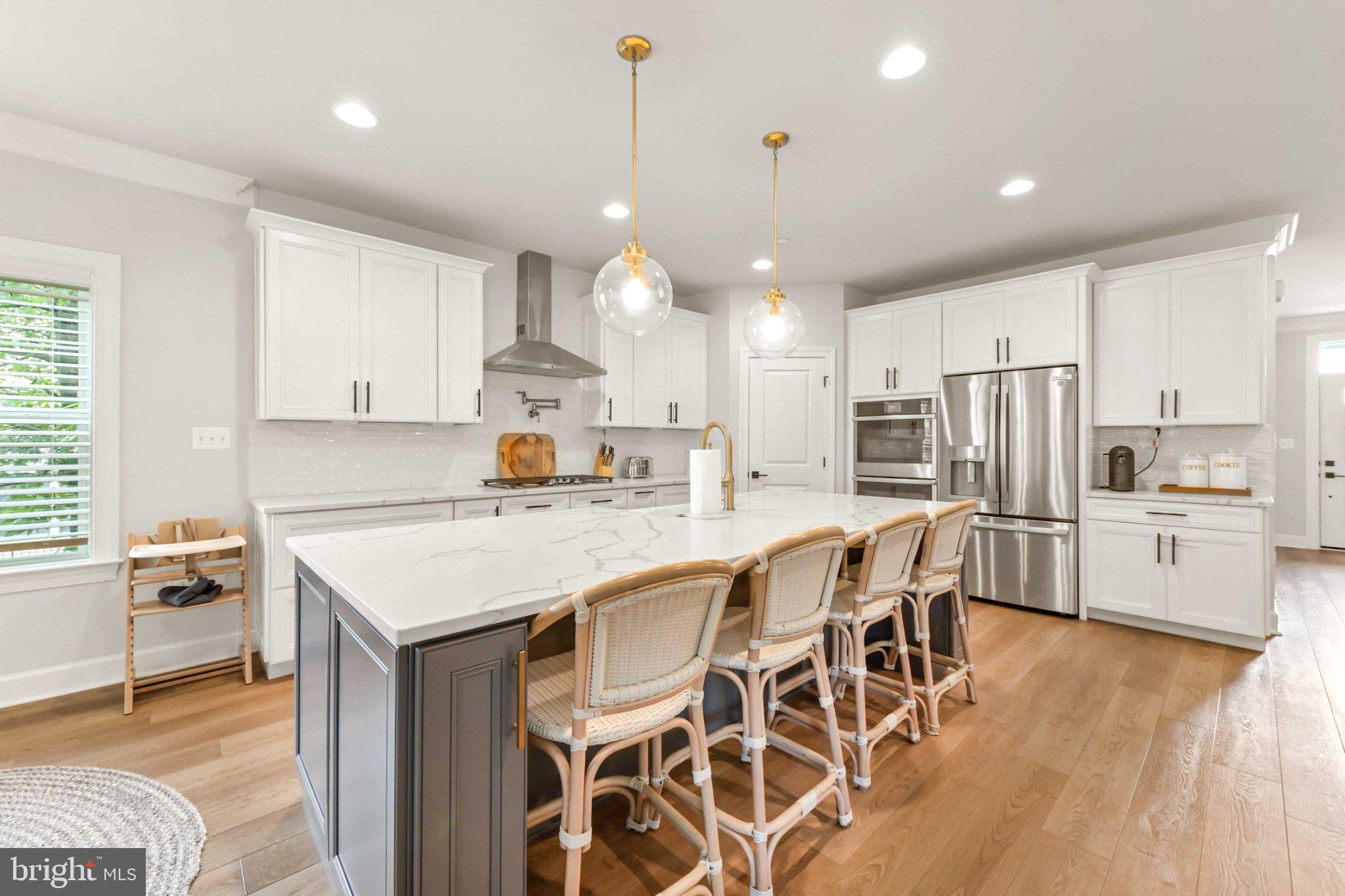 6310 Winters Lane Hanover, MD 21076 - Photo 13 of 76 a kitchen with stainless steel appliances a stove a sink island and a refrigerator