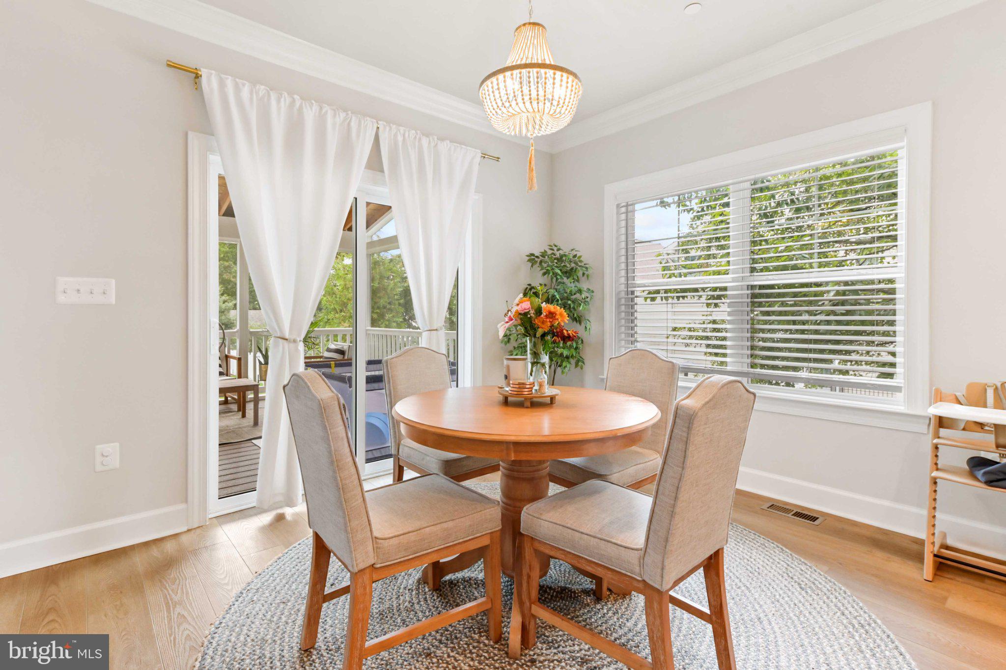 6310 Winters Lane Hanover, MD 21076 - Photo 21 of 76 a view of a dining room with furniture window and wooden floor