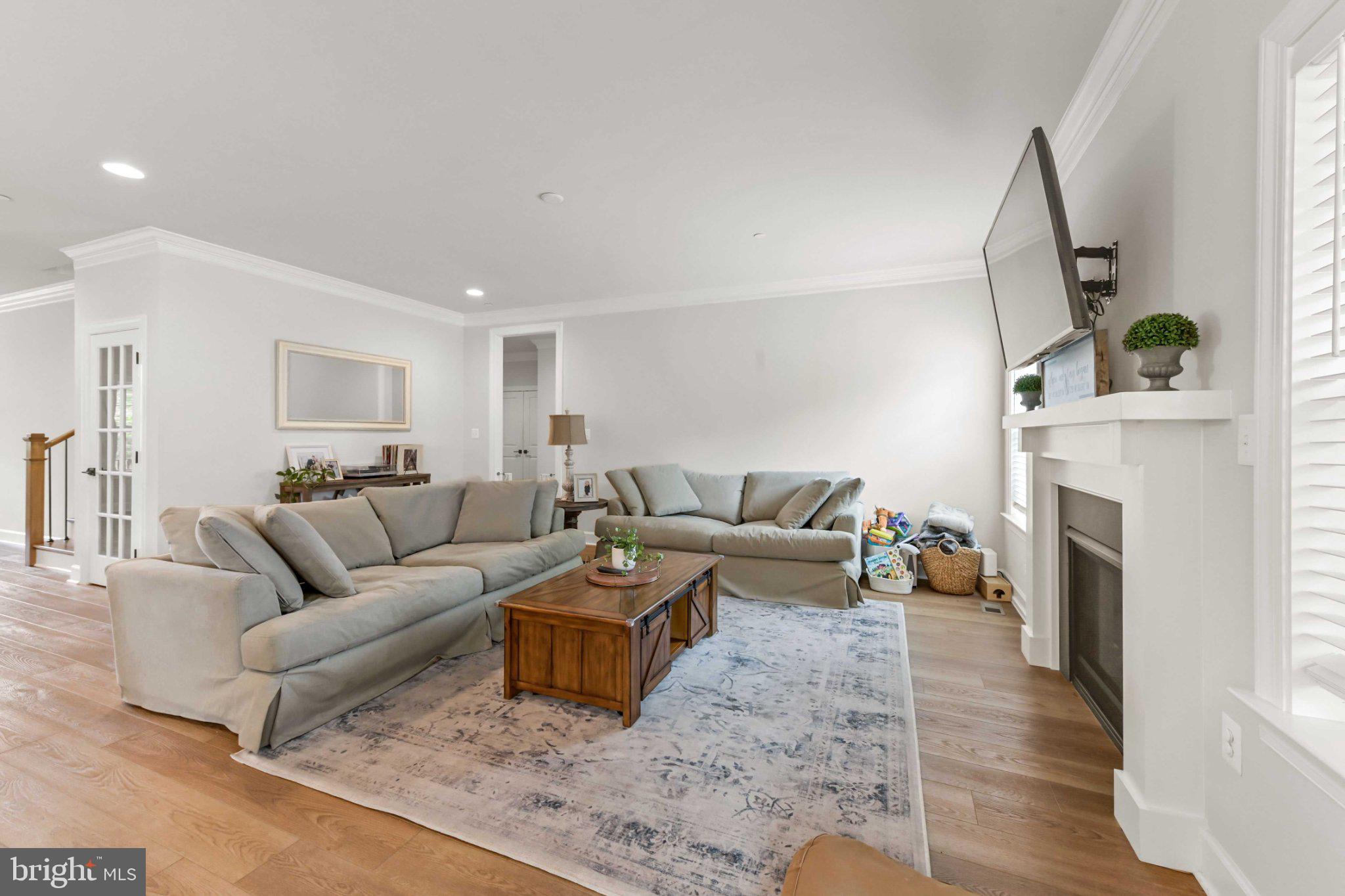 6310 Winters Lane Hanover, MD 21076 - Photo 25 of 76 a living room with furniture a fireplace and a flat screen tv