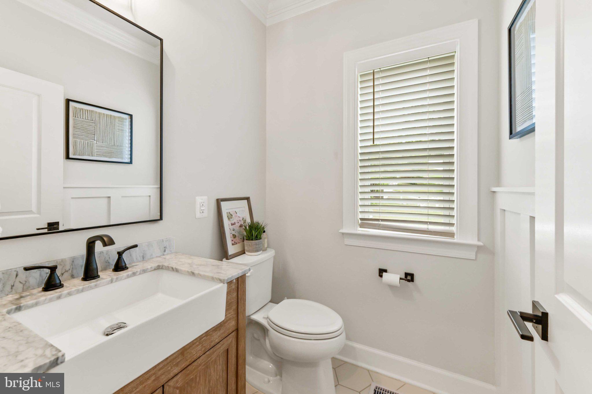 6310 Winters Lane Hanover, MD 21076 - Photo 32 of 76 a bathroom with a sink toilet and a mirror
