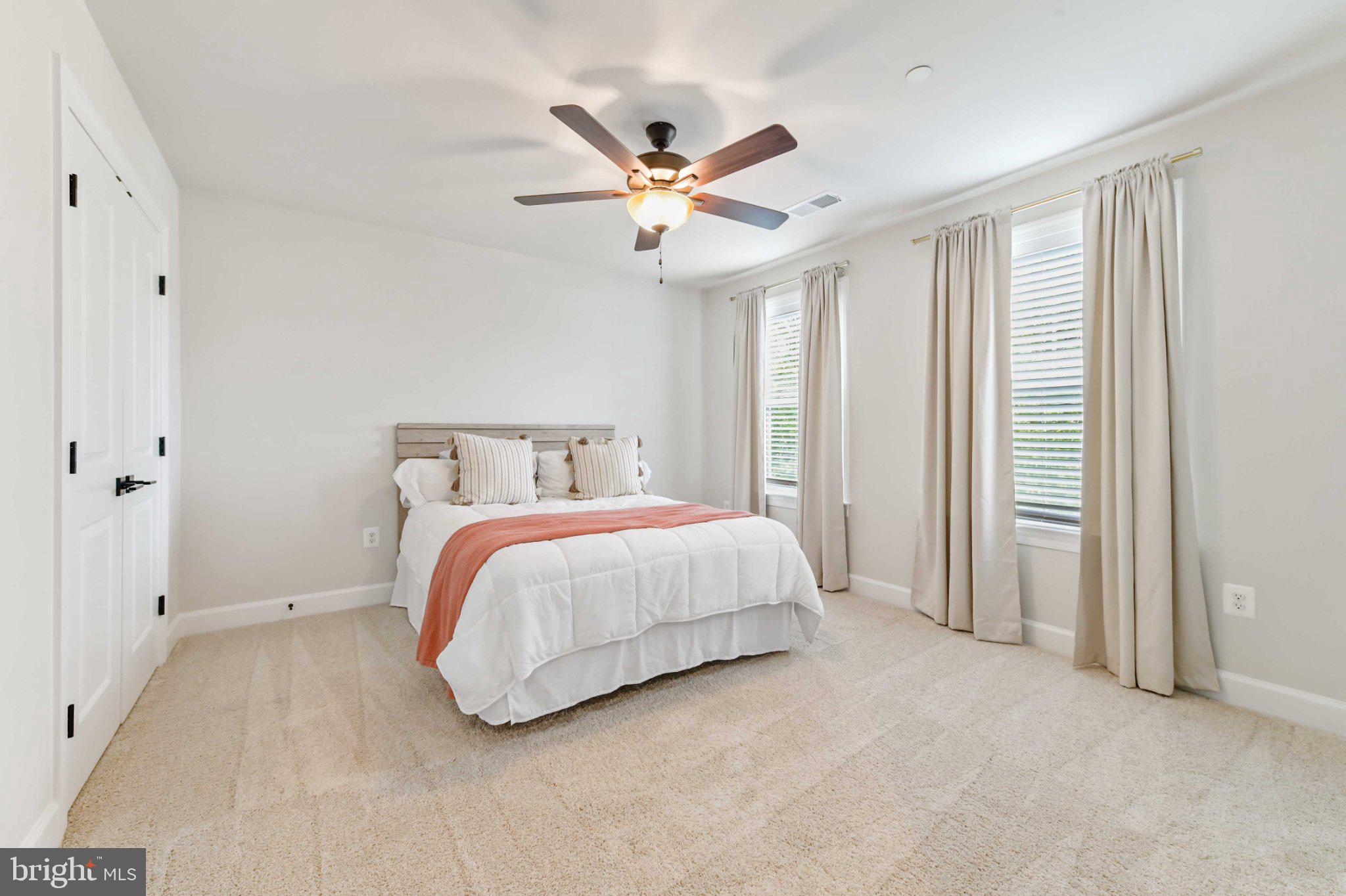 6310 Winters Lane Hanover, MD 21076 - Photo 38 of 76 a bed room with a bed and a ceiling fan