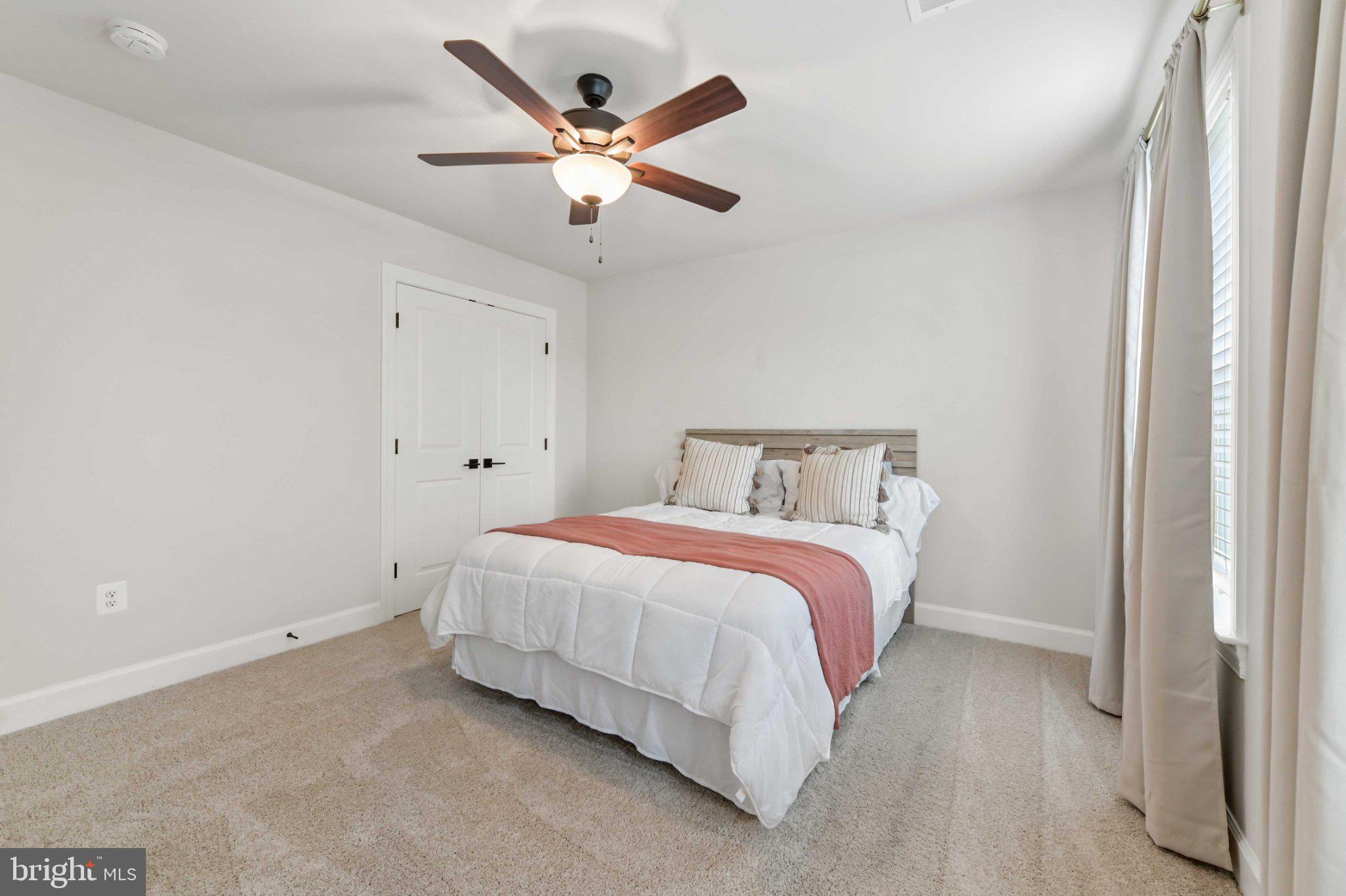 6310 Winters Lane Hanover, MD 21076 - Photo 39 of 76 a bedroom with a large bed and a chandelier