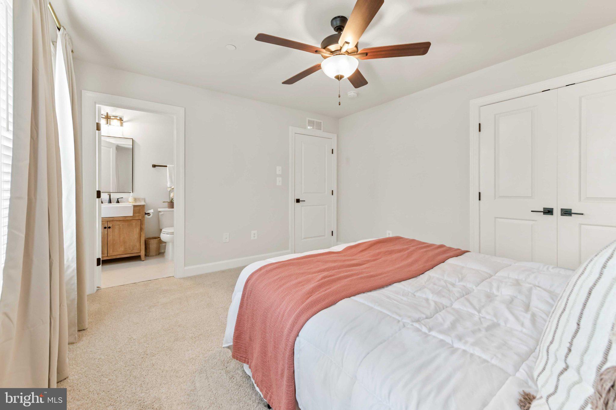 6310 Winters Lane Hanover, MD 21076 - Photo 40 of 76 a spacious bedroom with a bed and a chandelier
