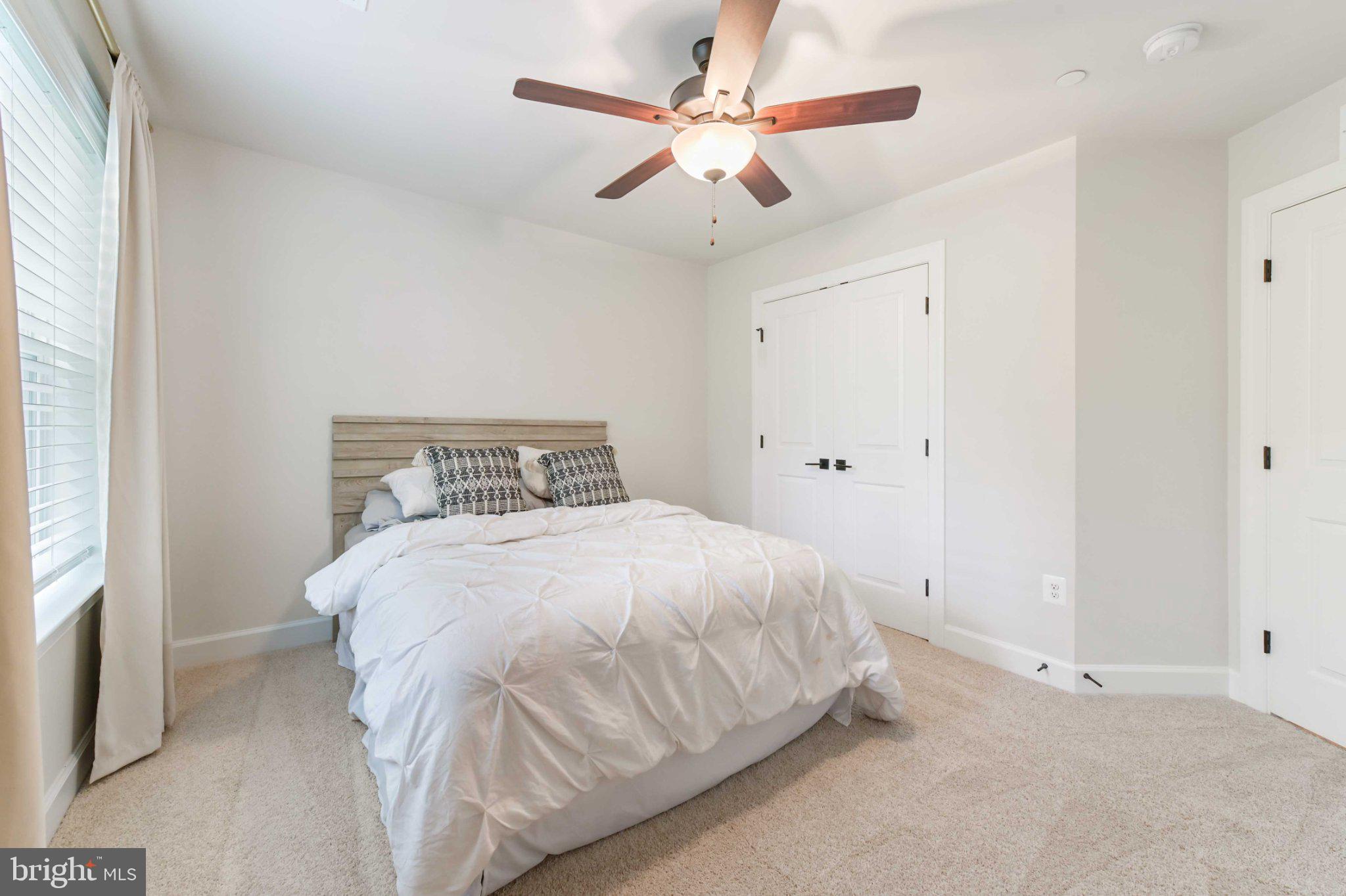 6310 Winters Lane Hanover, MD 21076 - Photo 42 of 76 a bedroom with a bed and a ceiling fan