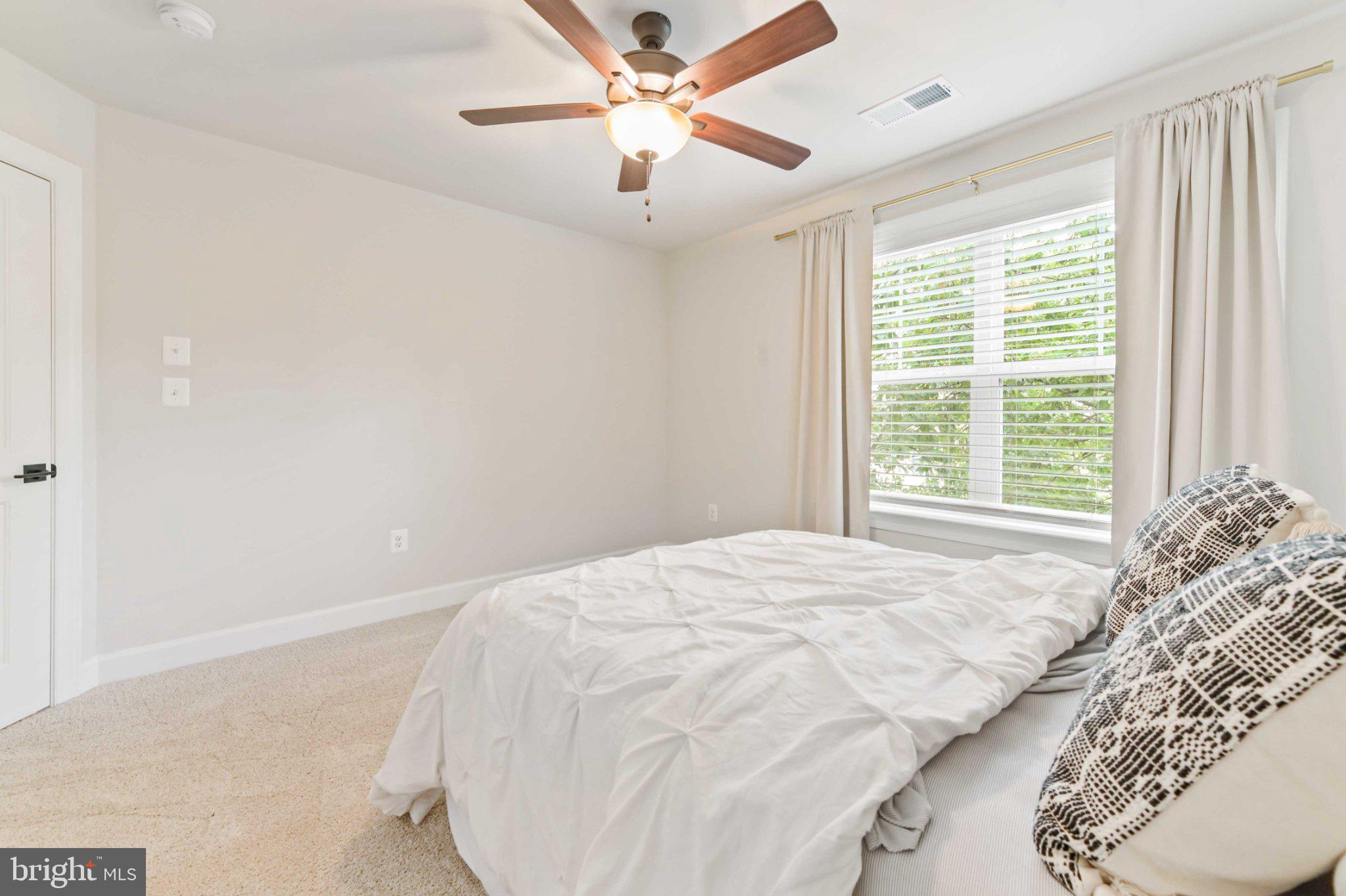 6310 Winters Lane Hanover, MD 21076 - Photo 43 of 76 a bedroom with a bed and a large window