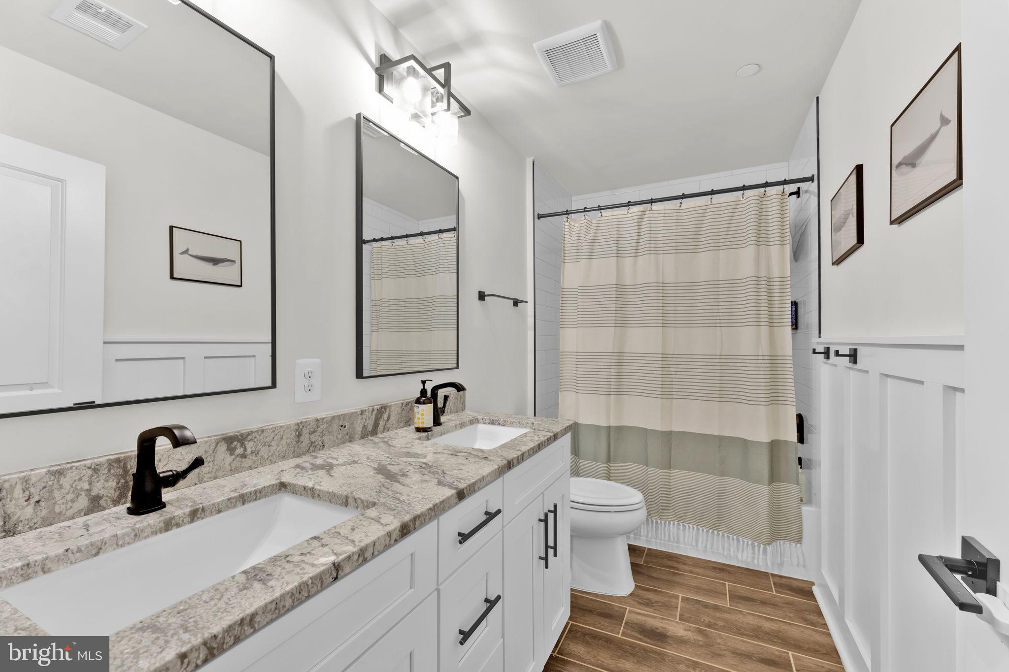 6310 Winters Lane Hanover, MD 21076 - Photo 44 of 76 a bathroom with a granite countertop sink toilet and shower
