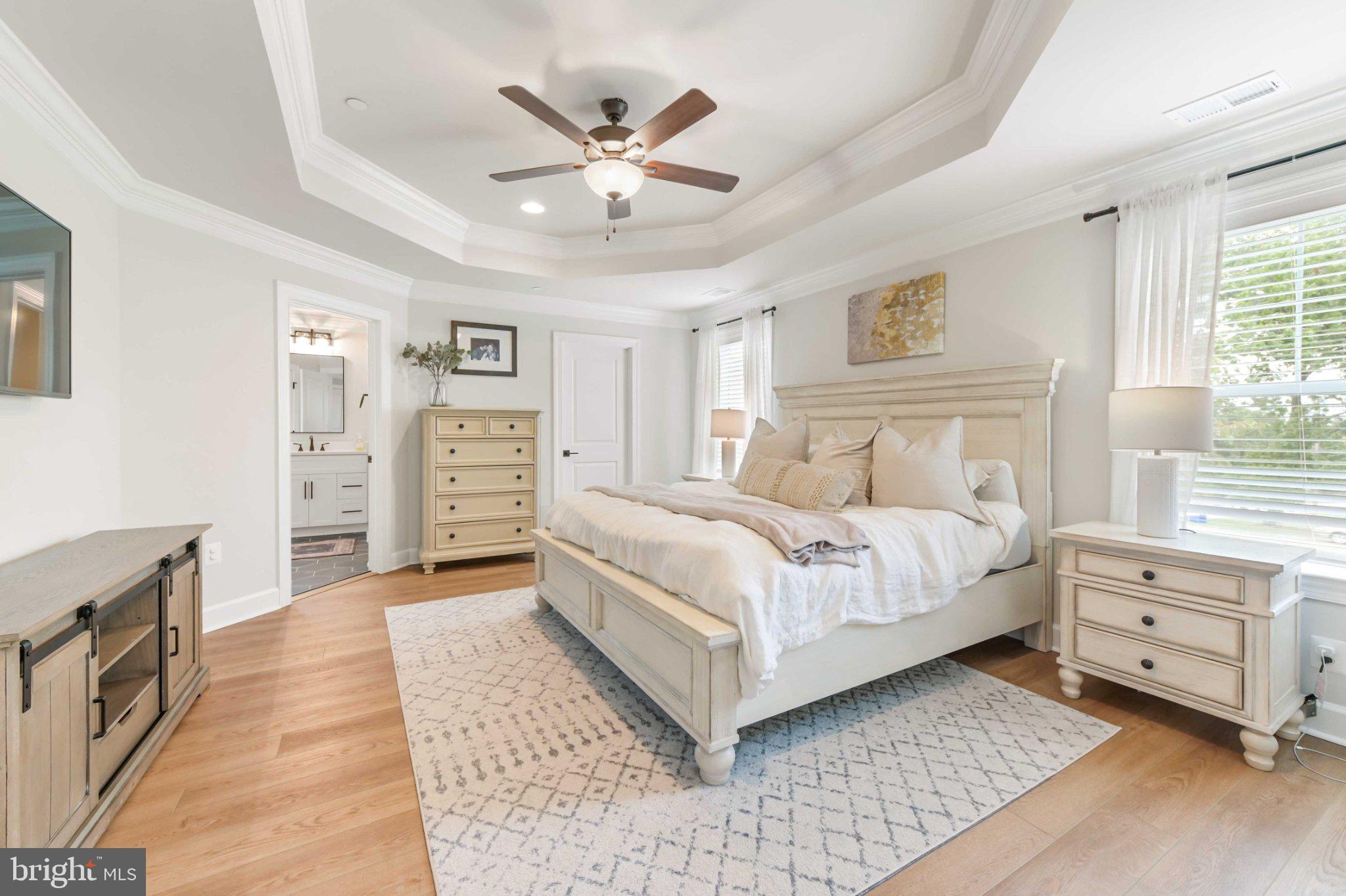 6310 Winters Lane Hanover, MD 21076 - Photo 46 of 76 a bedroom with a large bed and a chandelier