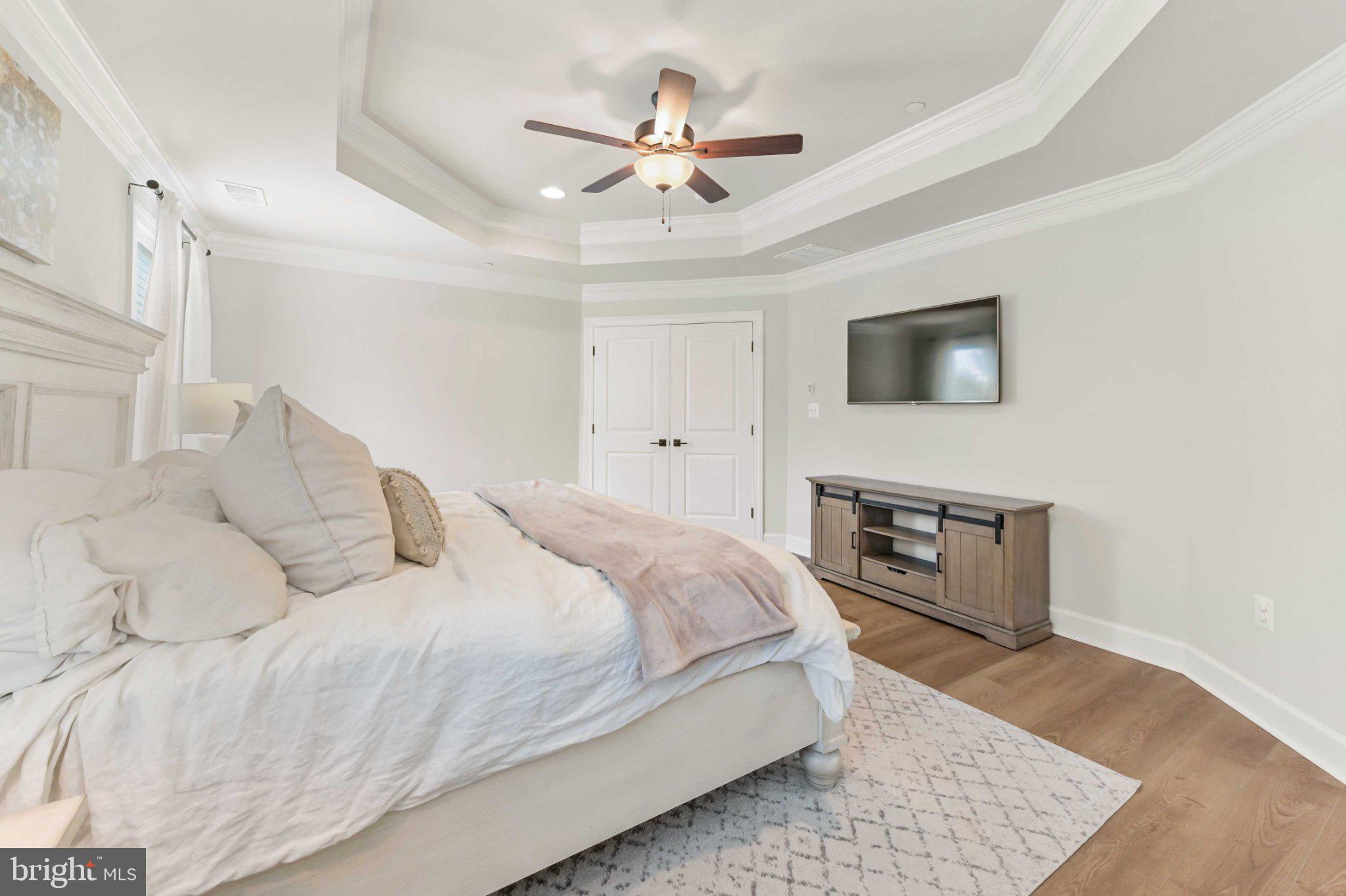 6310 Winters Lane Hanover, MD 21076 - Photo 47 of 76 a spacious bedroom with a bed and a flat screen tv