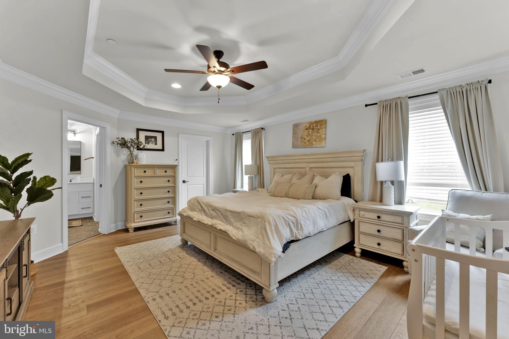 6310 Winters Lane Hanover, MD 21076 - Photo 49 of 76 a spacious bedroom with a large bed and a chandelier