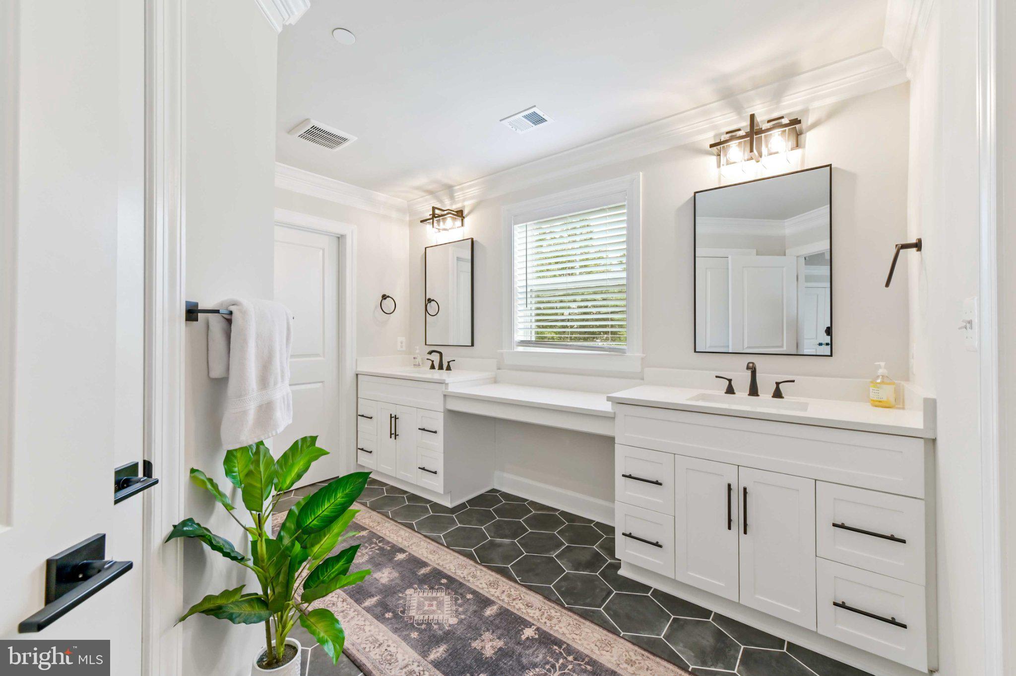 6310 Winters Lane Hanover, MD 21076 - Photo 51 of 76 a bathroom with a granite countertop sink a toilet and a mirror