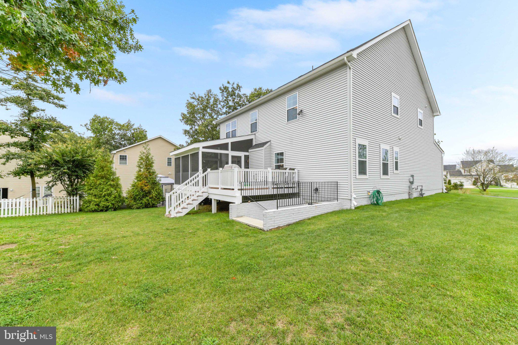 6310 Winters Lane Hanover, MD 21076 - Photo 59 of 76 a view of a white house with a big yard and large trees