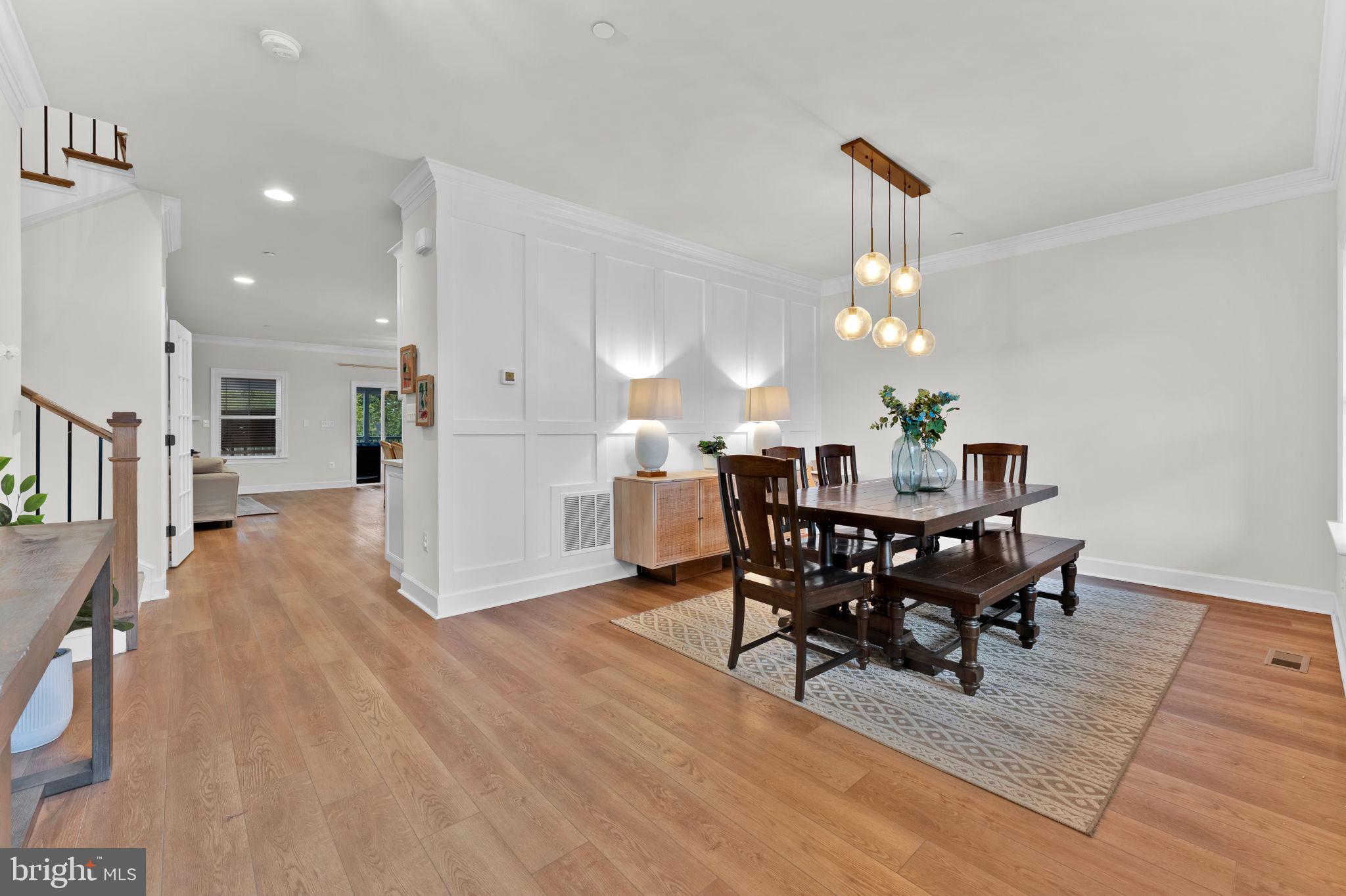 6310 Winters Lane Hanover, MD 21076 - Photo 6 of 76 a view of a dining room with furniture and wooden floor