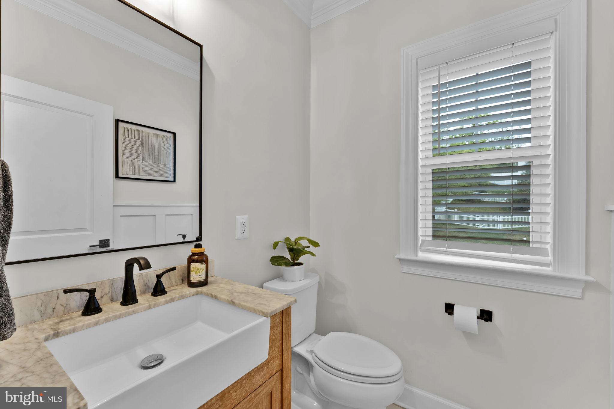 6310 Winters Lane Hanover, MD 21076 - Photo 65 of 76 a bathroom with a sink vanity granite toilet and a mirror