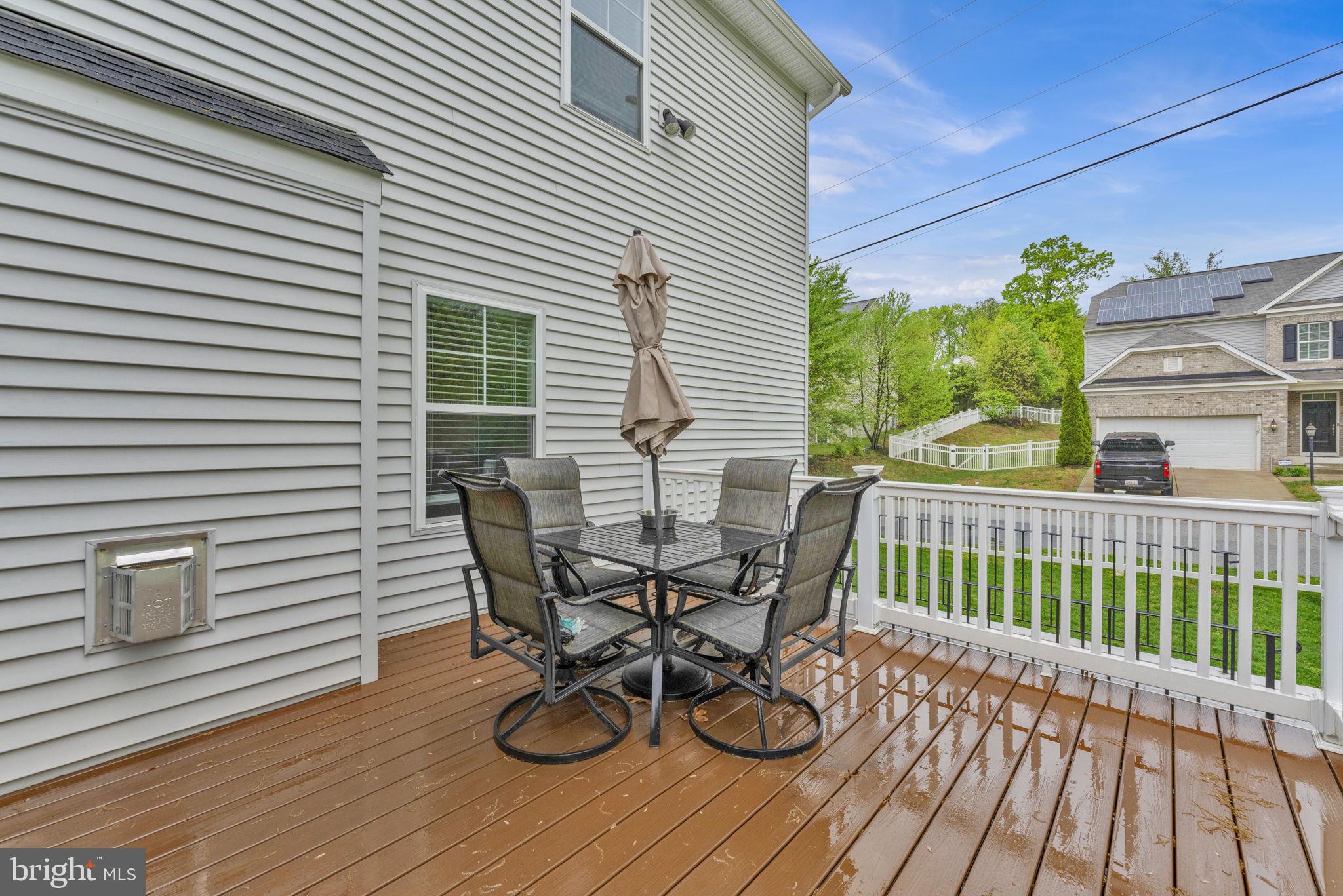 6310 Winters Lane Hanover, MD 21076 - Photo 70 of 76 a view of a patio with table and chairs and wooden floor