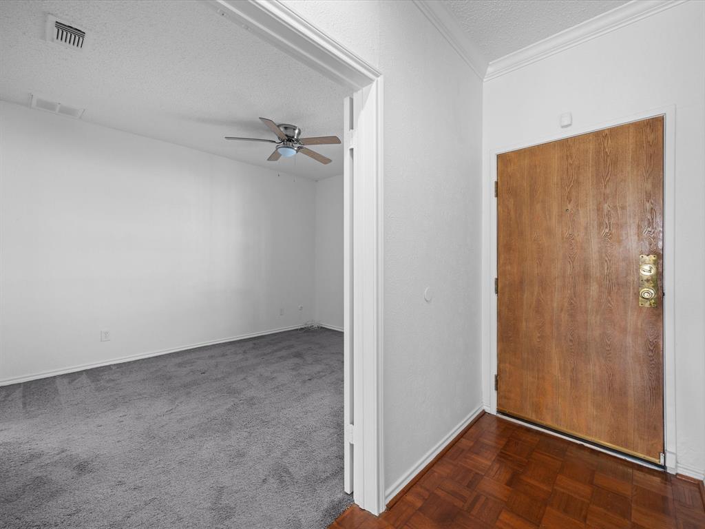 5310 Keller Springs Road, Unit 332 Dallas, TX 75248 - Photo 20 of 39 Foyer with a textured ceiling, ceiling fan, and dark carpet