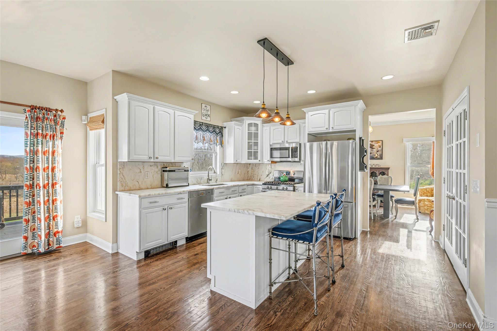 67 Liberty Corners Road Pine Island, NY 10969 - Photo 12 of 42 a large white kitchen with lots of counter top space and stainless steel appliances