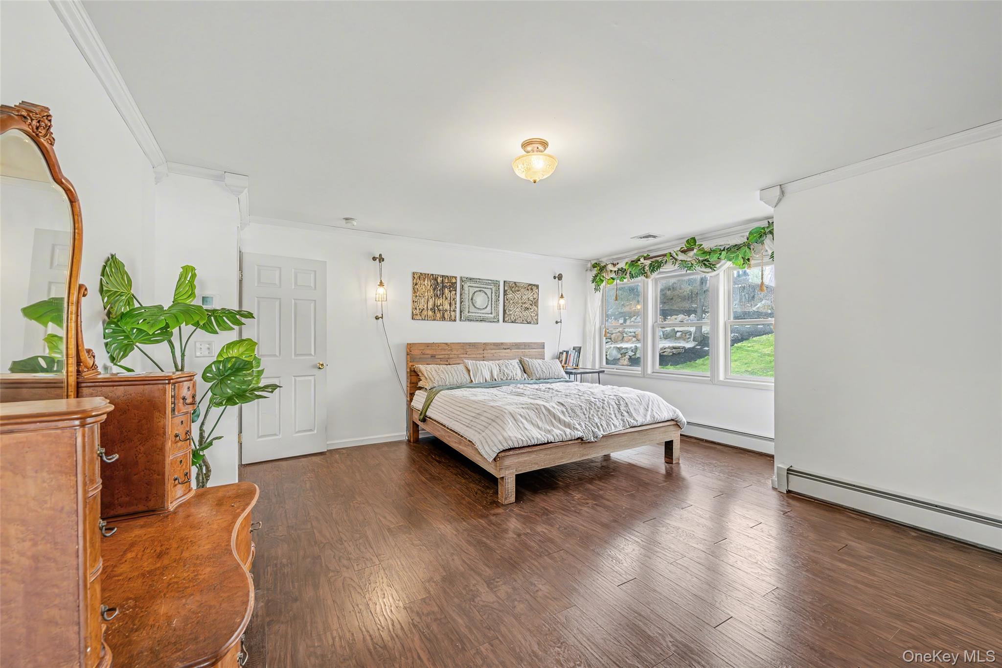 67 Liberty Corners Road Pine Island, NY 10969 - Photo 23 of 42 a living room with a bed furniture and a potted plant