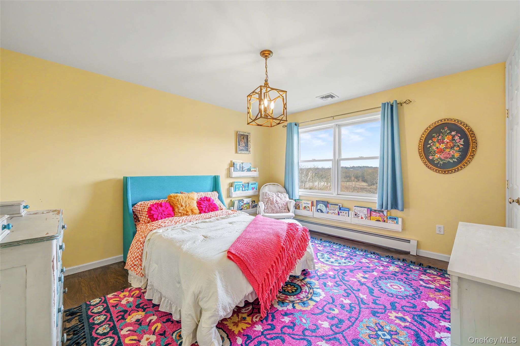 67 Liberty Corners Road Pine Island, NY 10969 - Photo 27 of 42 a bedroom with a bed and a chandelier