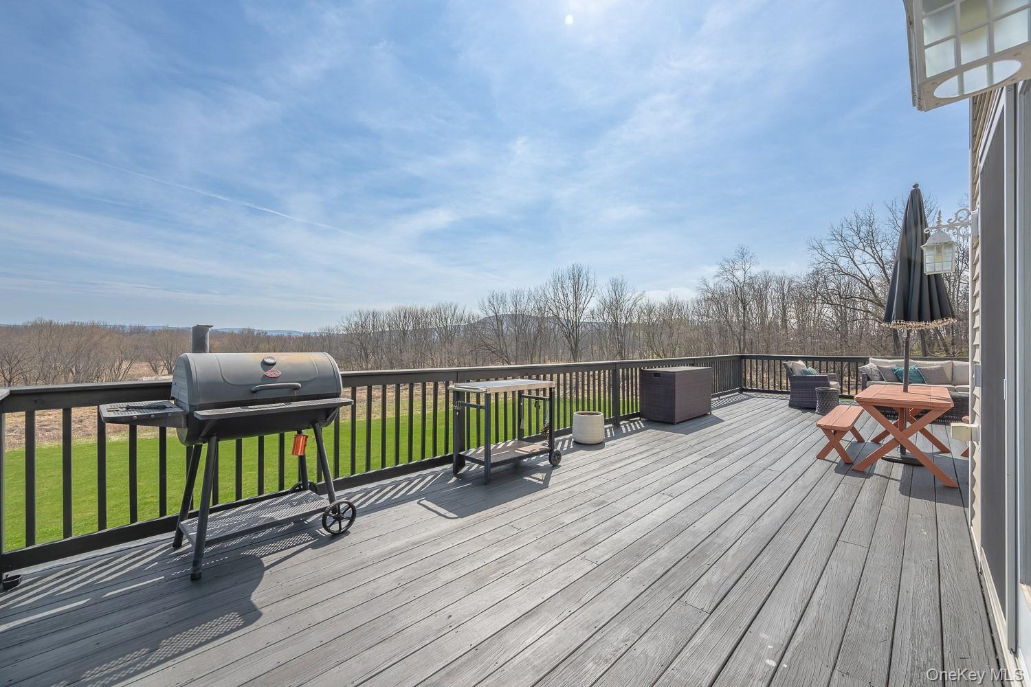 67 Liberty Corners Road Pine Island, NY 10969 - Photo 39 of 42 a view of a balcony with two chairs and wooden floor