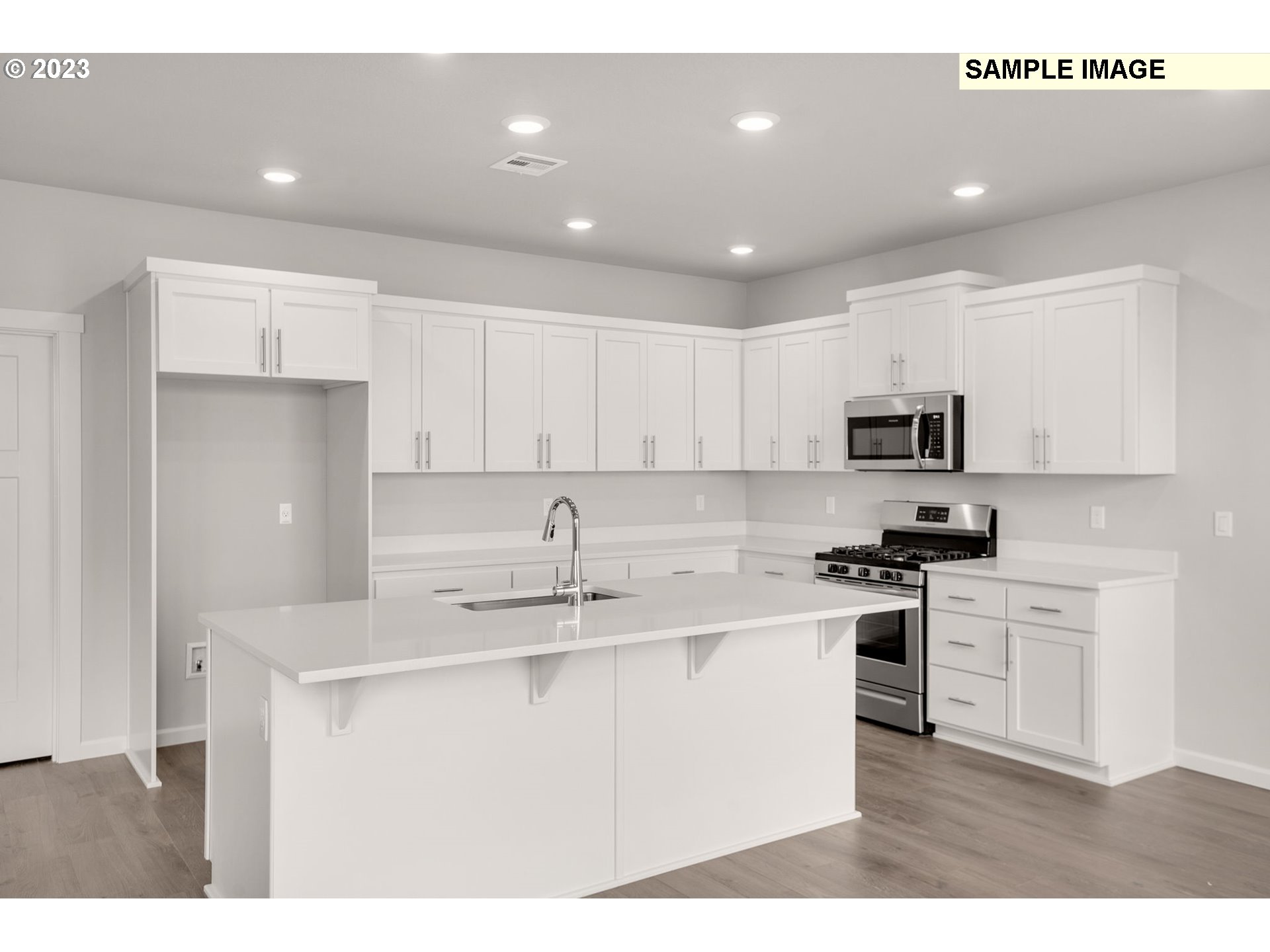 2193 Southeast Osprey Avenue Gresham, OR 97080 - Photo 5 of 24 a kitchen with stainless steel appliances granite countertop a sink stove and white cabinets