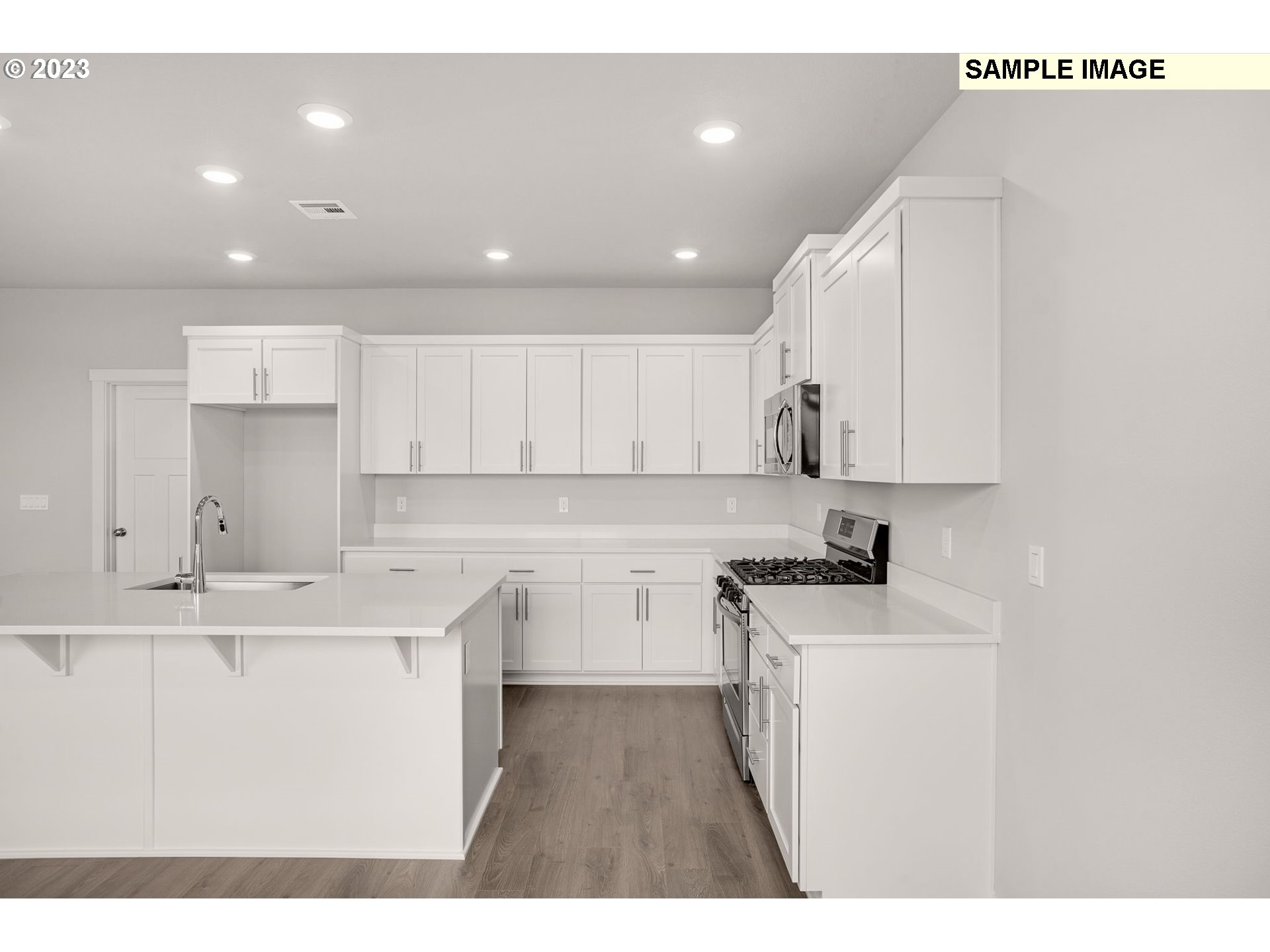 2193 Southeast Osprey Avenue Gresham, OR 97080 - Photo 6 of 24 a kitchen with a sink a stove a refrigerator and white cabinets