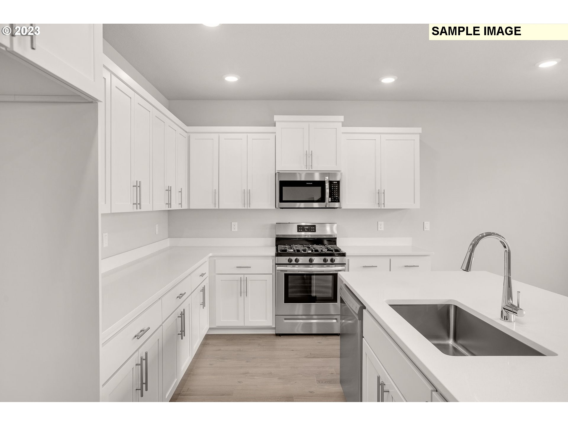 2193 Southeast Osprey Avenue Gresham, OR 97080 - Photo 7 of 24 a kitchen with white cabinets and appliances