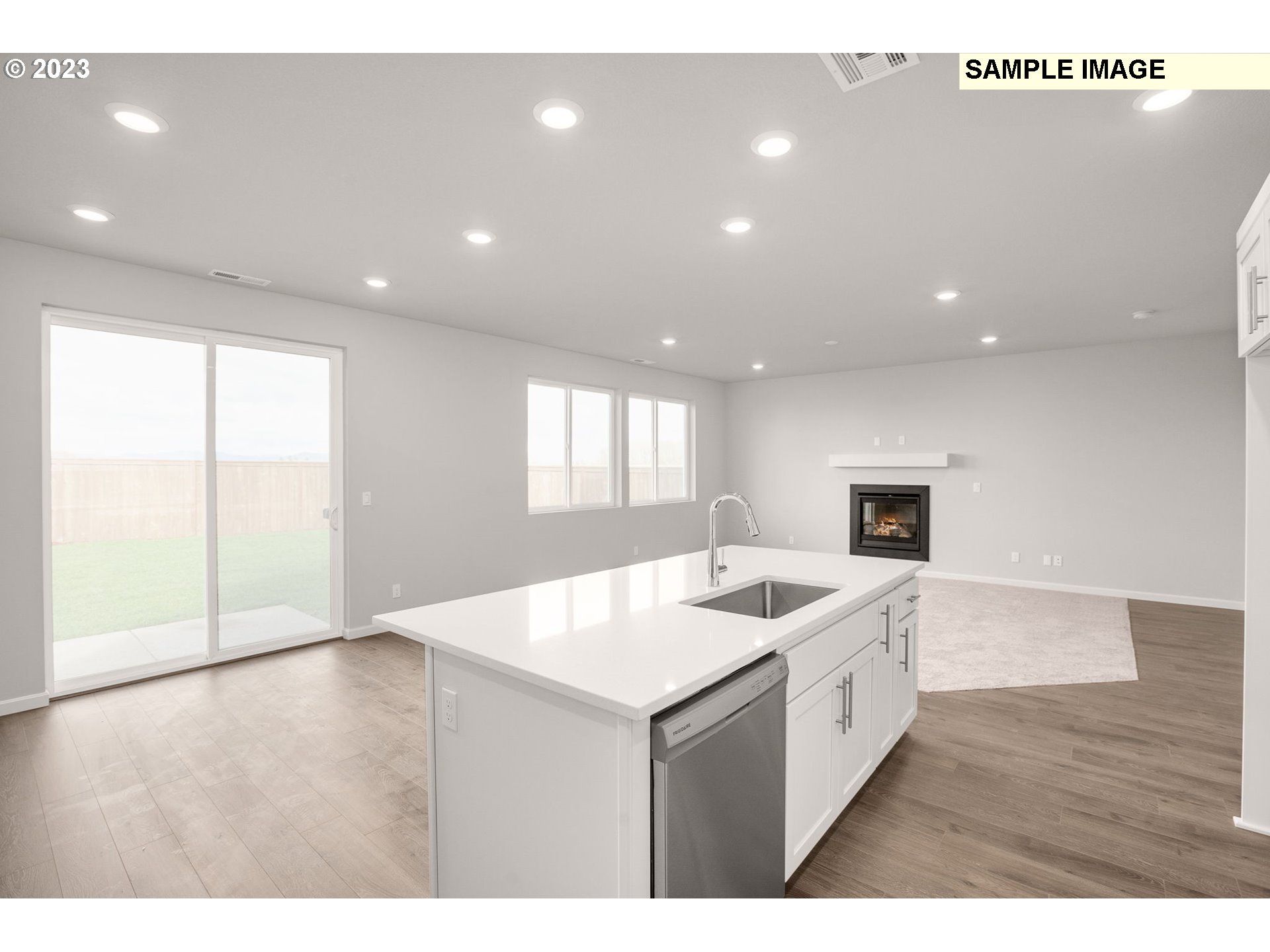 2193 Southeast Osprey Avenue Gresham, OR 97080 - Photo 8 of 24 a open kitchen with kitchen island a sink dishwasher and a stove with wooden floor