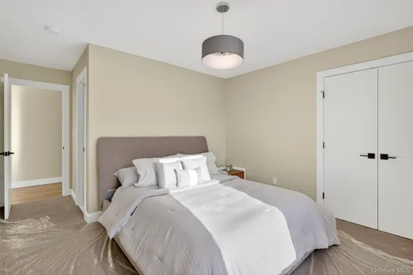 a bedroom with a bed and a night stand