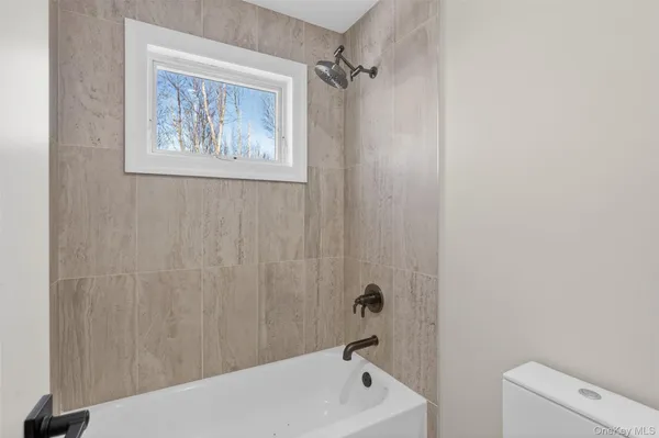 a bathroom with a bathtub and shower