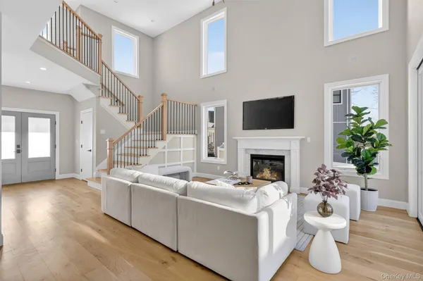 a living room with furniture a fireplace and a flat screen tv
