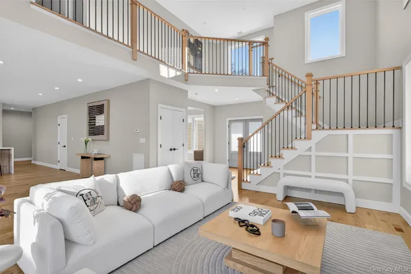 a living room with furniture hardwood floor and a table