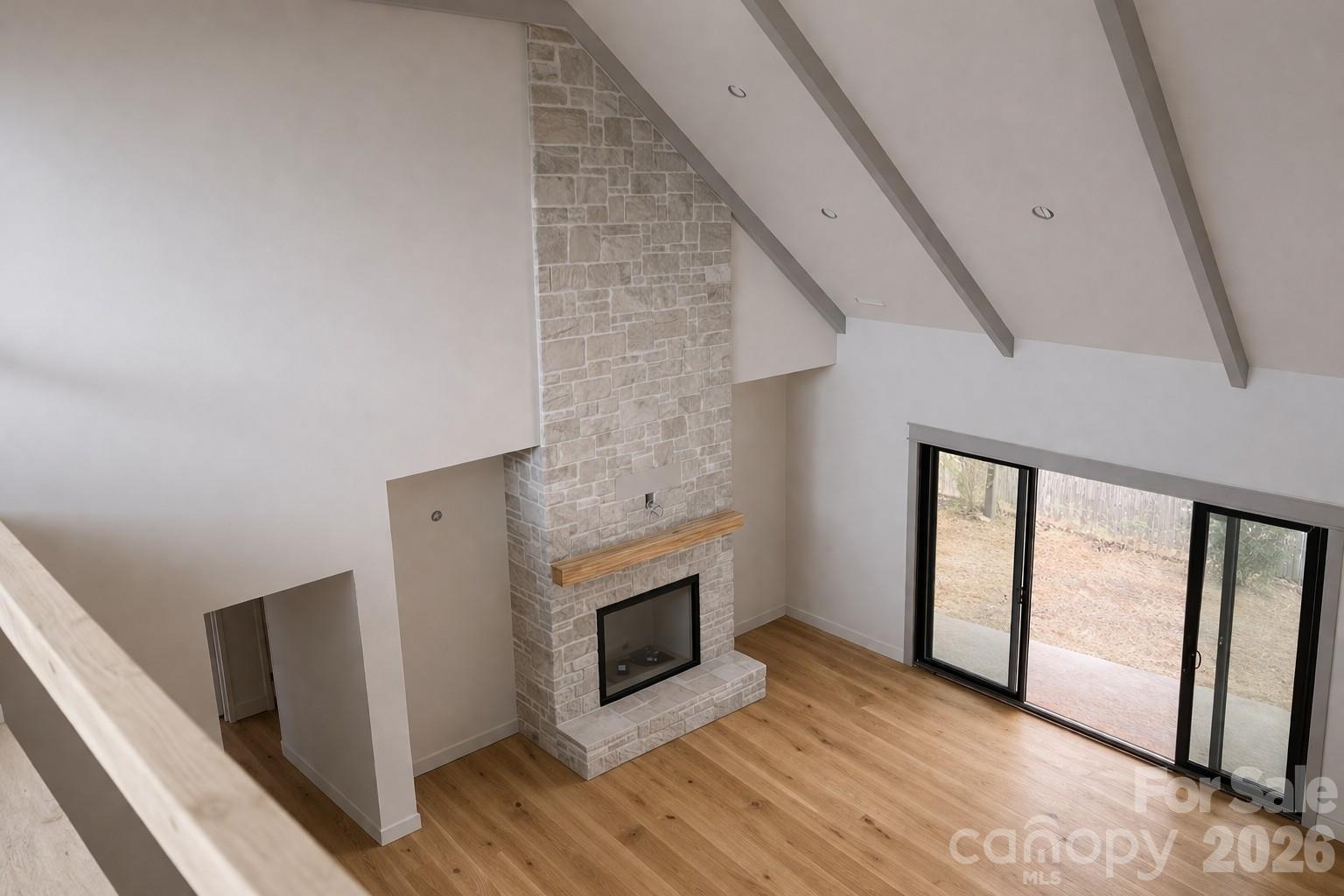25 Emory Paige Road Weaverville, NC 28787 - Photo 12 of 20 a view of a livingroom with wooden floor and a fireplace