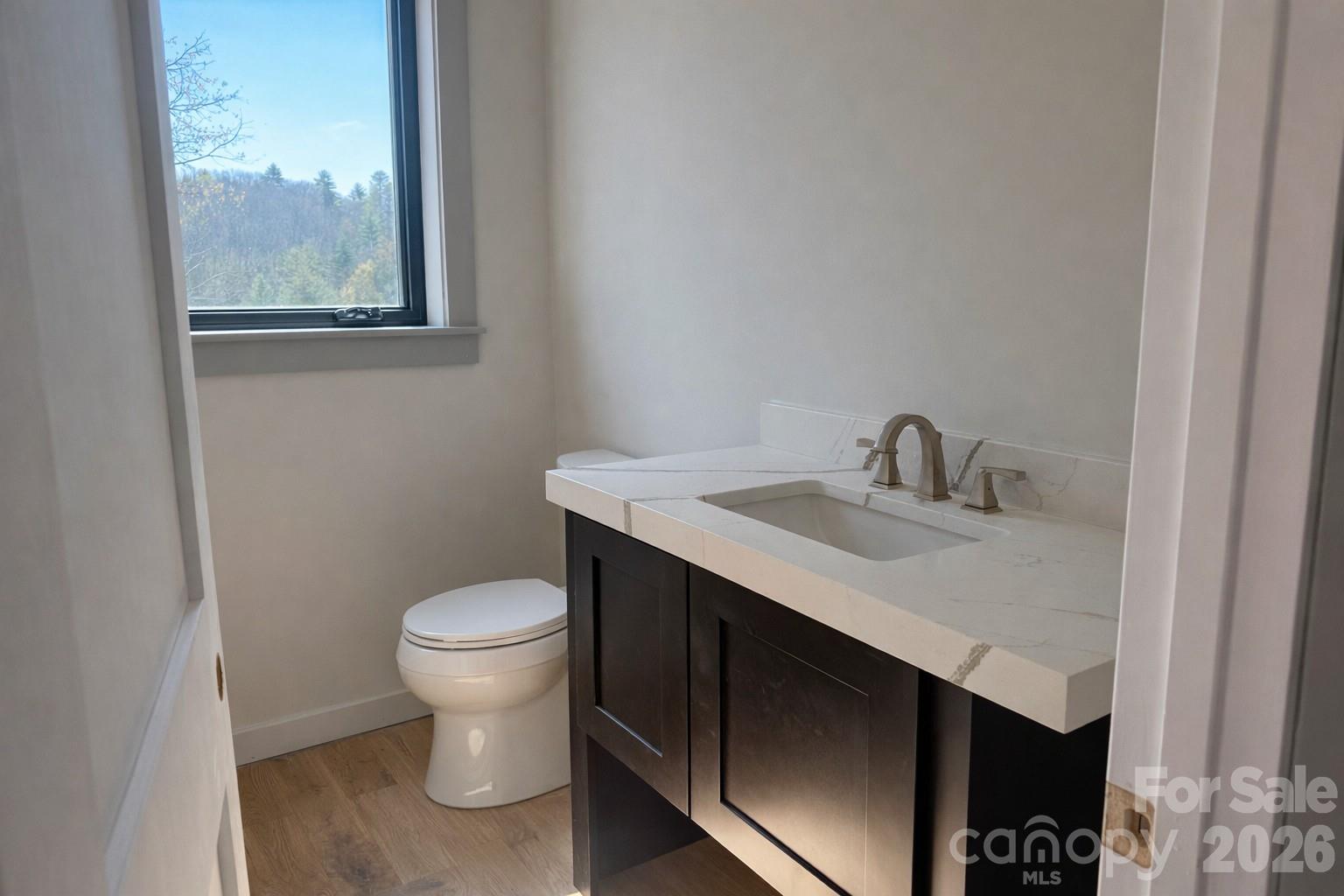 25 Emory Paige Road Weaverville, NC 28787 - Photo 15 of 20 a bathroom with a sink toilet and a window
