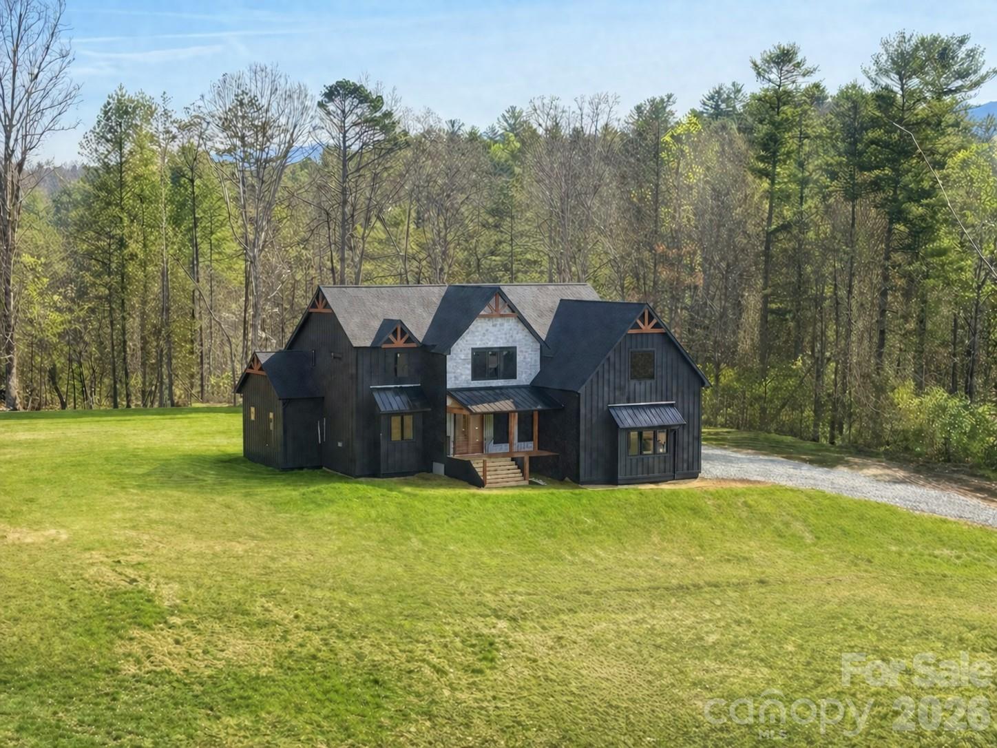 25 Emory Paige Road Weaverville, NC 28787 - Photo 2 of 20 a view of a house with a big yard and large trees