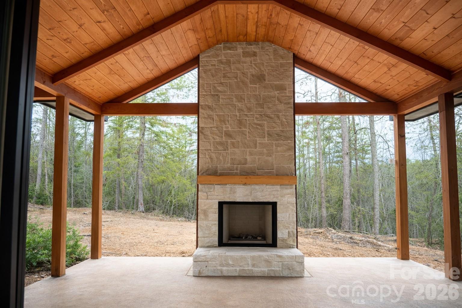 25 Emory Paige Road Weaverville, NC 28787 - Photo 7 of 20 a living room with a fireplace and a floor to ceiling window