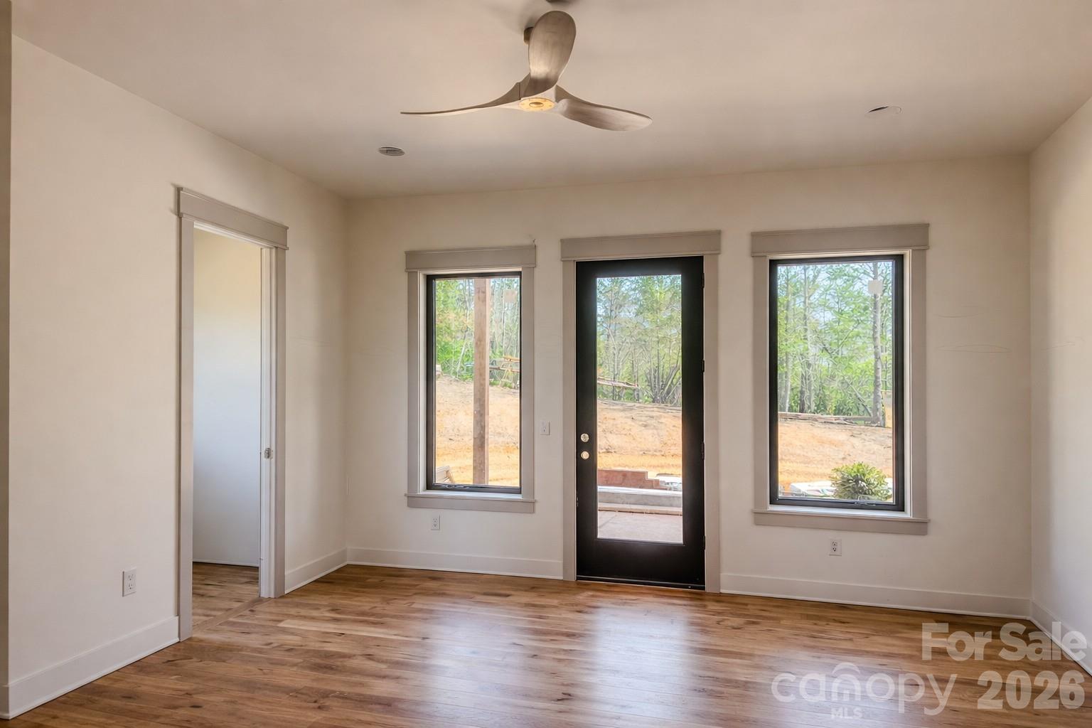 25 Emory Paige Road Weaverville, NC 28787 - Photo 8 of 20 a view of an empty room with a window and wooden floor