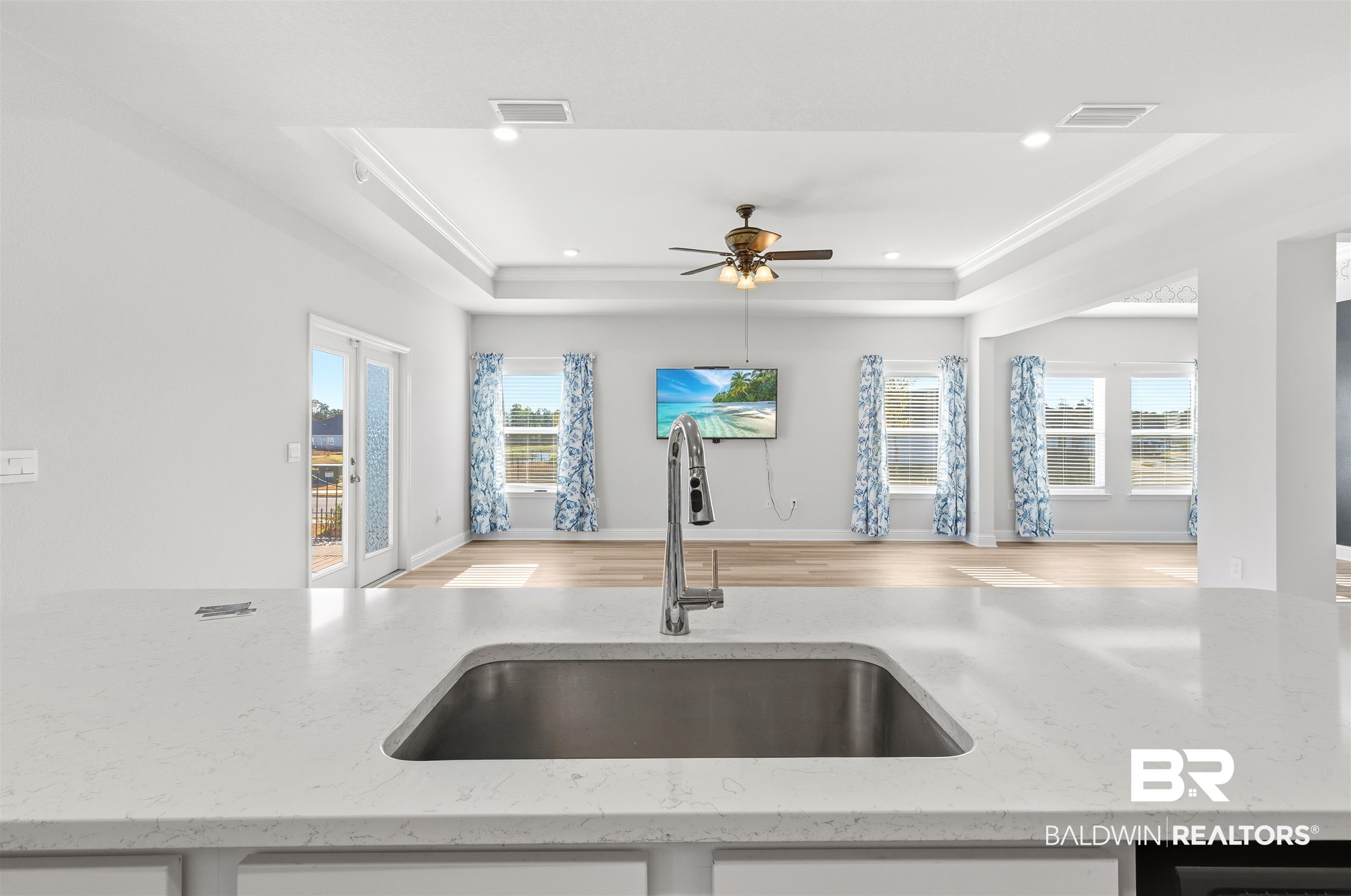 485 Shepard Street Gulf Shores, AL 36542 - Photo 53 of 53 Kitchen with light stone counters, open floor plan, plenty of natural light, a tray ceiling, and recessed lighting