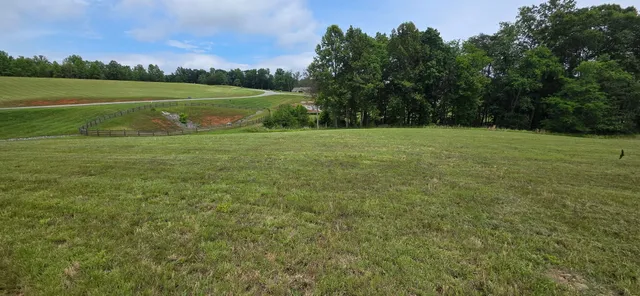 a view of field with river in the background