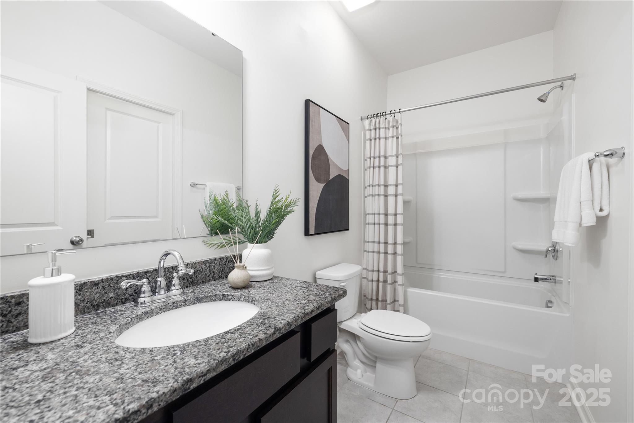 12536 Gotland Road, Unit 330 Midland, NC 28107 - Photo 16 of 28 a bathroom with a granite countertop sink toilet and shower