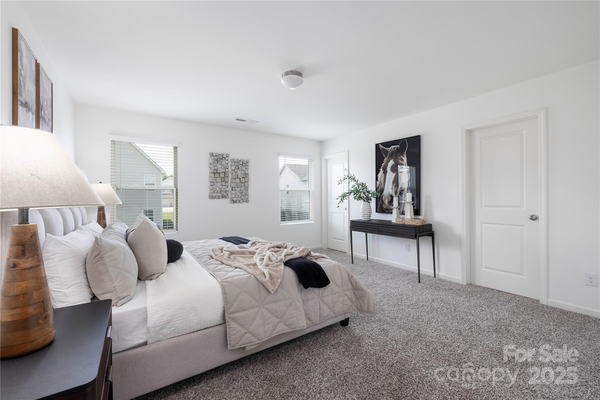 12536 Gotland Road, Unit 330 Midland, NC 28107 - Photo 17 of 28 a bedroom with a bed a table and painting on the wall
