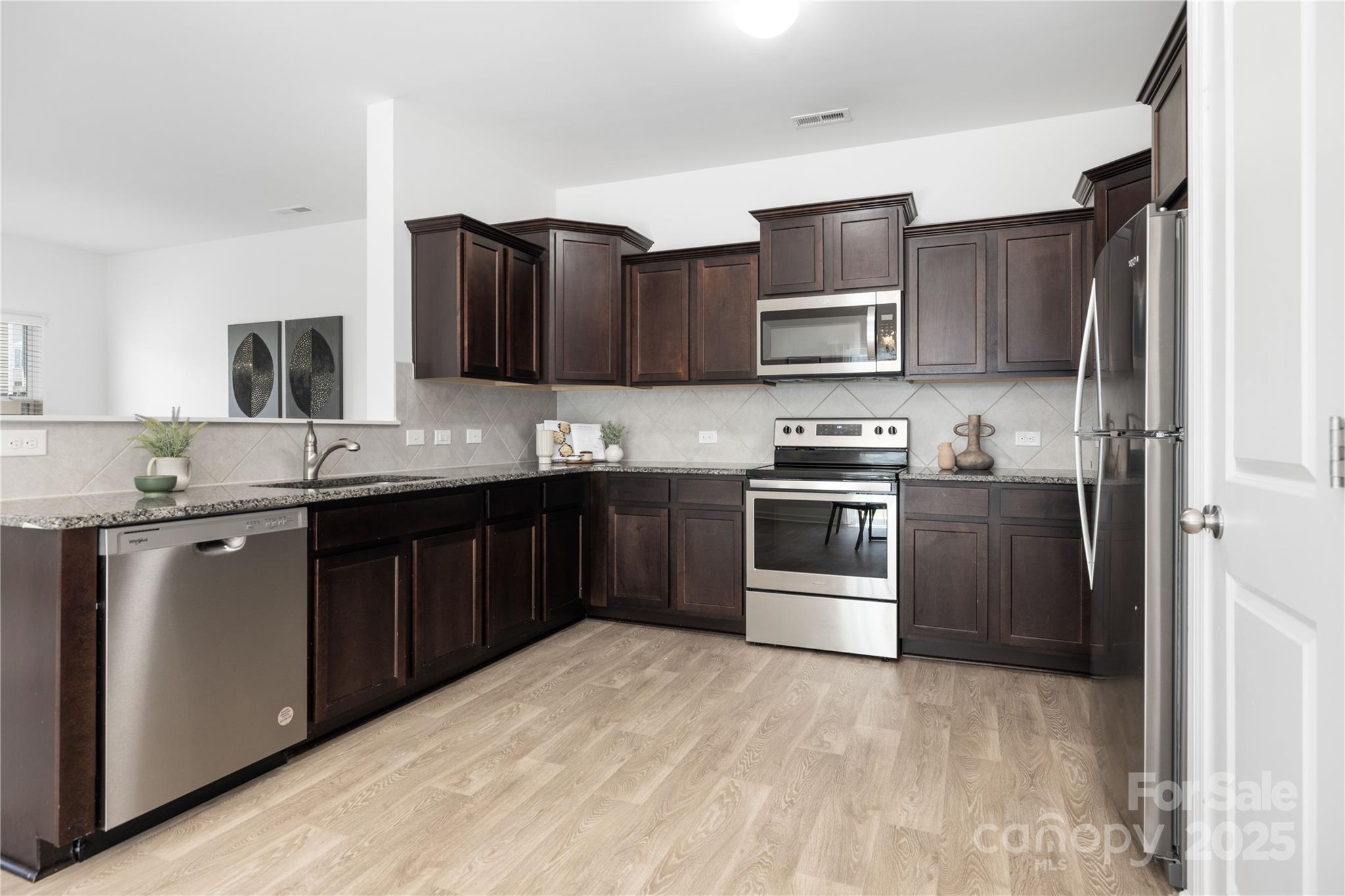 12536 Gotland Road, Unit 330 Midland, NC 28107 - Photo 10 of 28 a kitchen with stainless steel appliances and a stove top oven