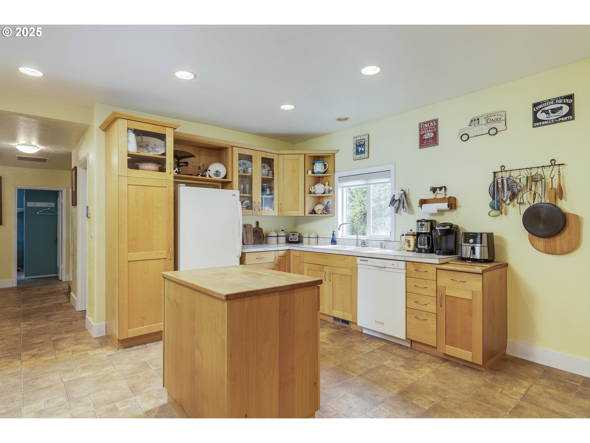8205 Southwest Broadmead Road Amity, OR 97101 - Photo 11 of 30 a kitchen that has a lot of cabinets a sink and a refrigerator