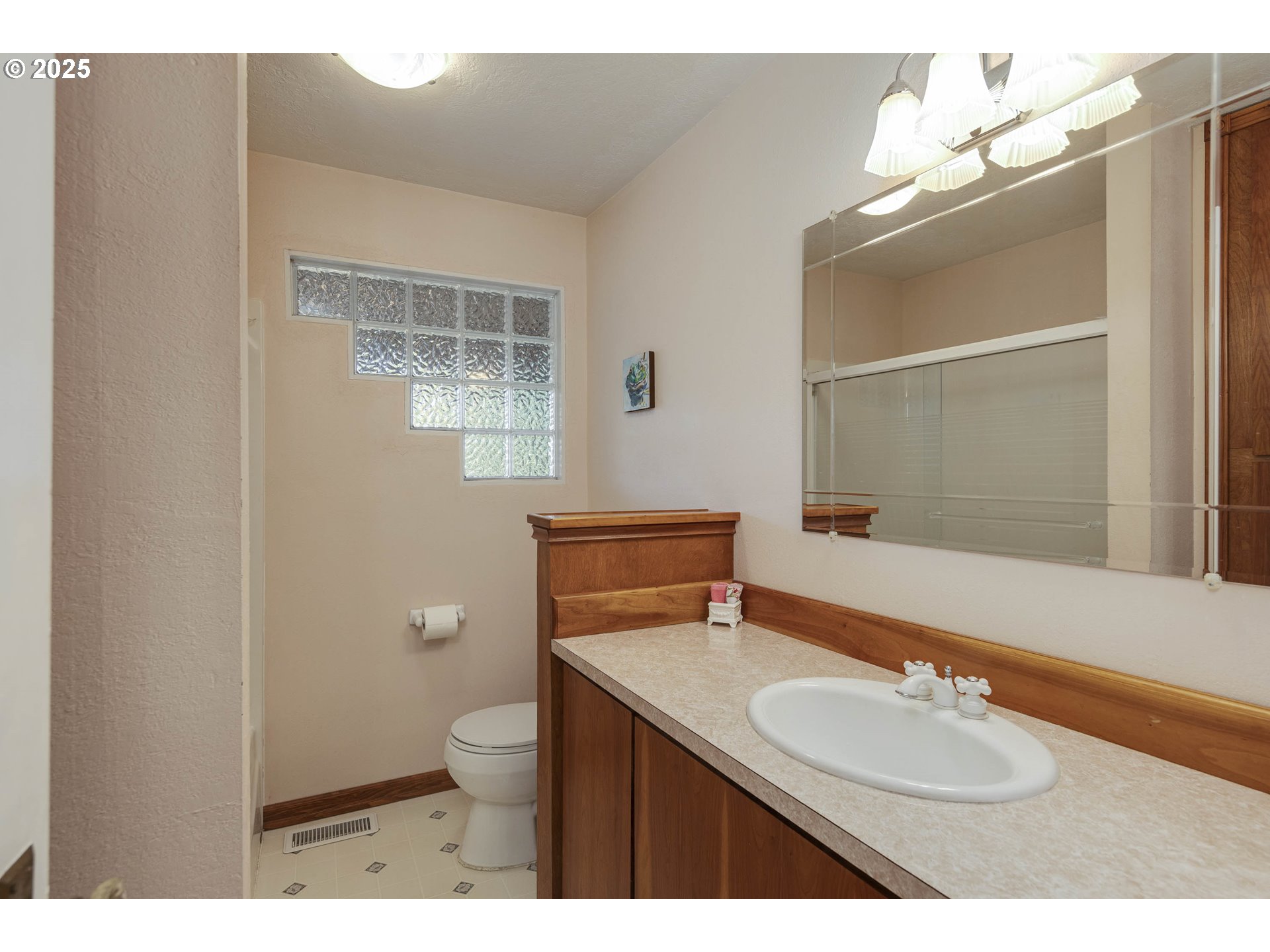 8205 Southwest Broadmead Road Amity, OR 97101 - Photo 17 of 30 a bathroom with a granite countertop sink a toilet and a mirror